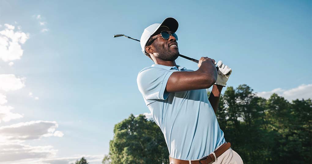 A man playing golf in the sun